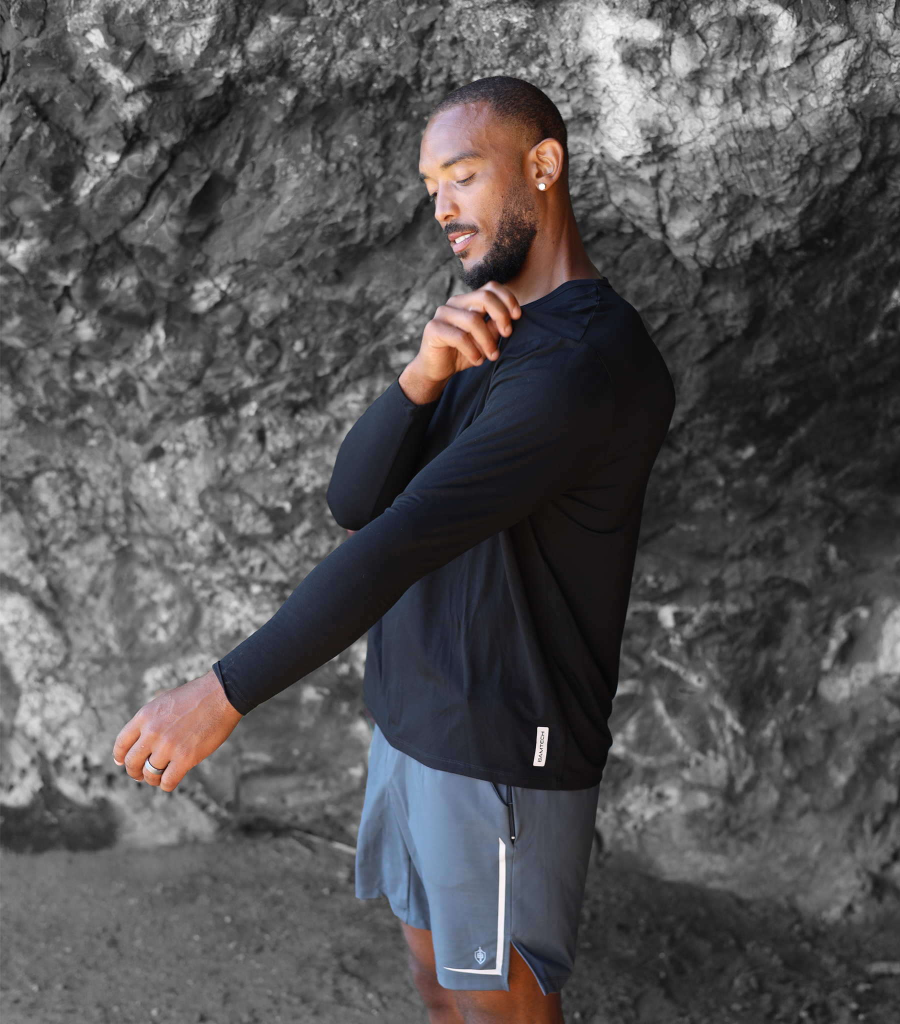 Man wearing our bamboo long sleeve shirt in black color. Man observing the fit and quality of the bamboo.